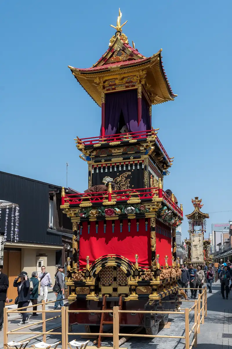 Gilded Takayama Matsuri float on display on Honmachi street, more floats lined up behind