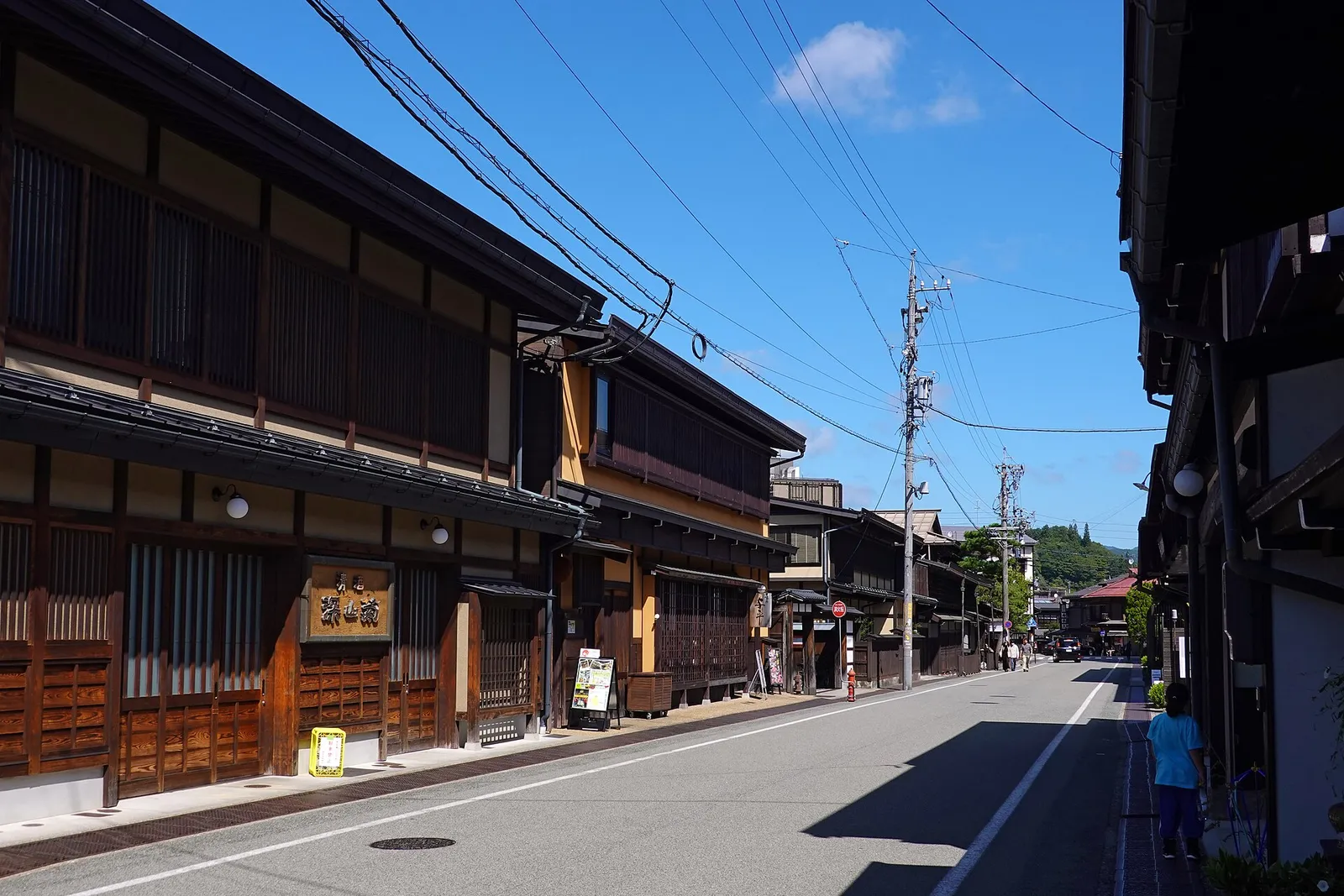 Sunny Sanmachi street lined with lattice-fronted merchant houses
