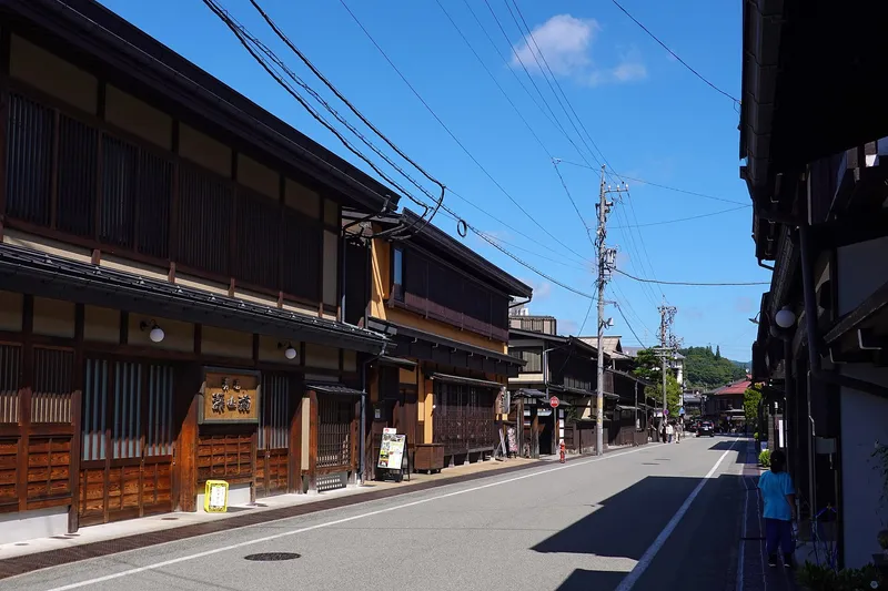 Sunny Sanmachi street lined with lattice-fronted merchant houses