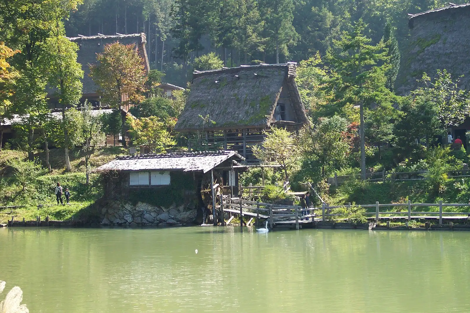Thatched houses and a water mill above the pond at Hida Folk Village