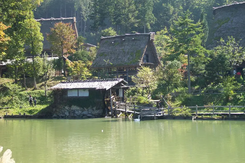 Thatched houses and a water mill above the pond at Hida Folk Village