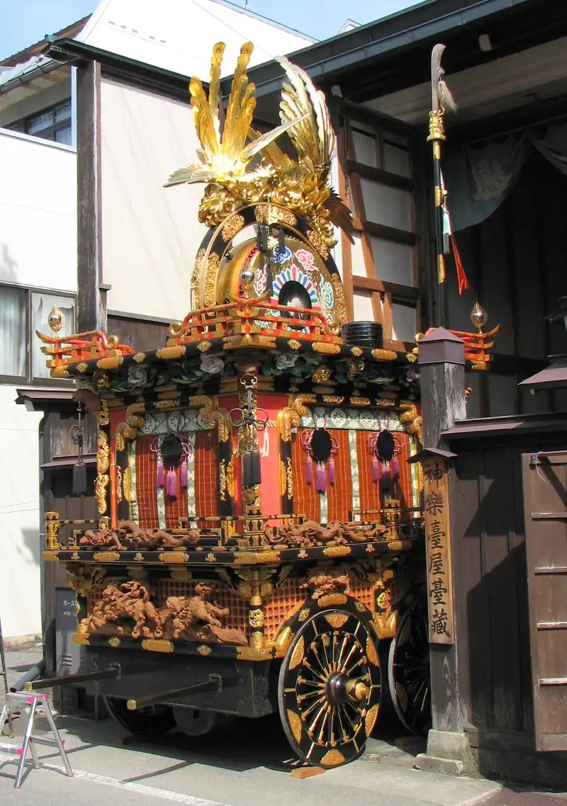 Kagura-tai festival float with its gilded phoenix top outside its storehouse in Takayama