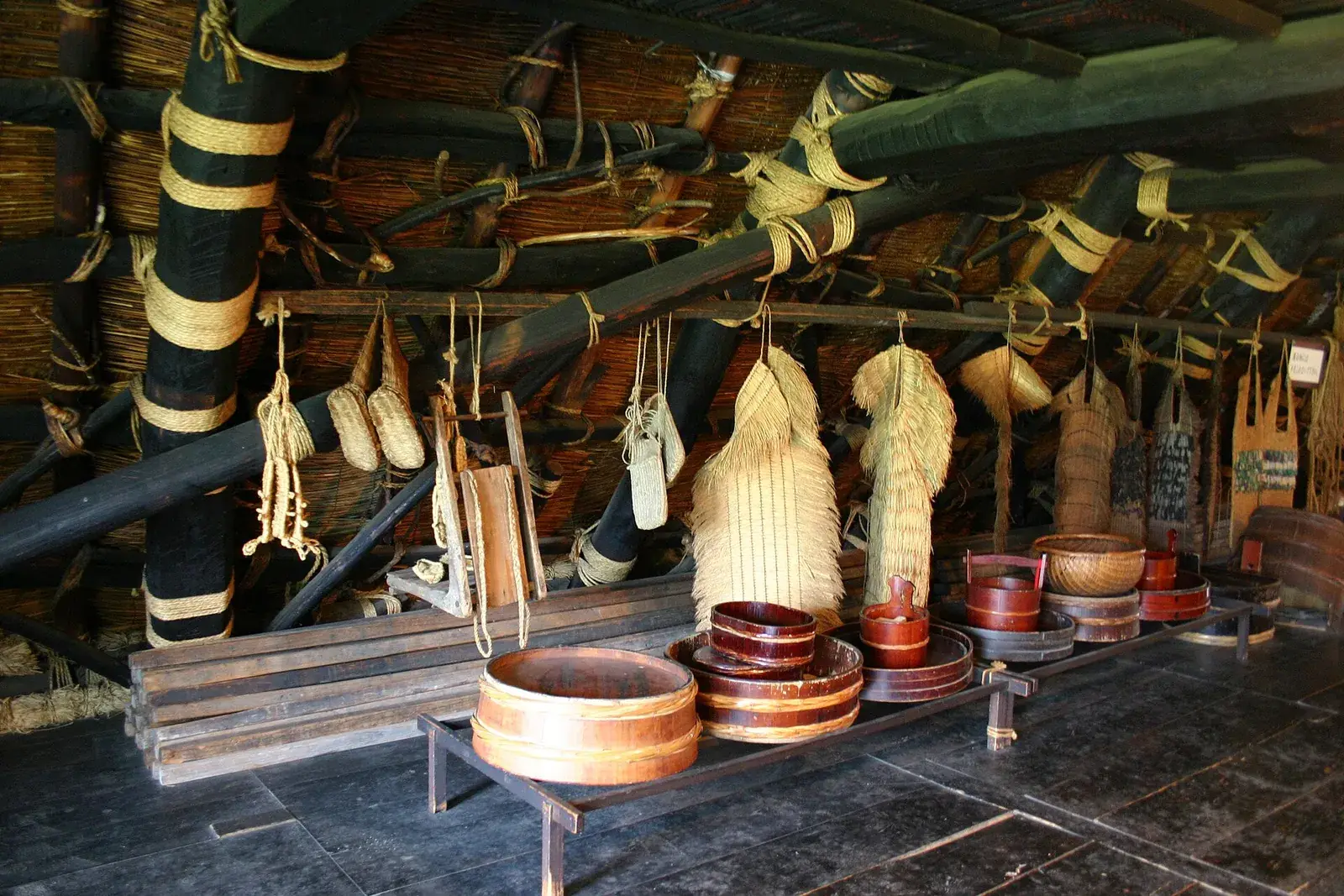 Straw rain capes, baskets and wooden tubs inside a gassho-zukuri farmhouse at Shirakawa-go