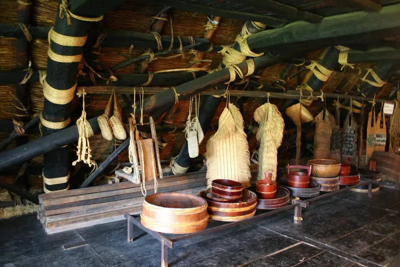 Straw rain capes, baskets and wooden tubs inside a gassho-zukuri farmhouse at Shirakawa-go